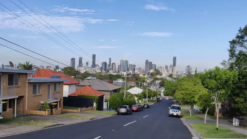 Buying a house in Brisbane with city view and street with houses