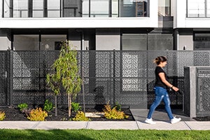 Block of townhouses by property developers with a girl walking past