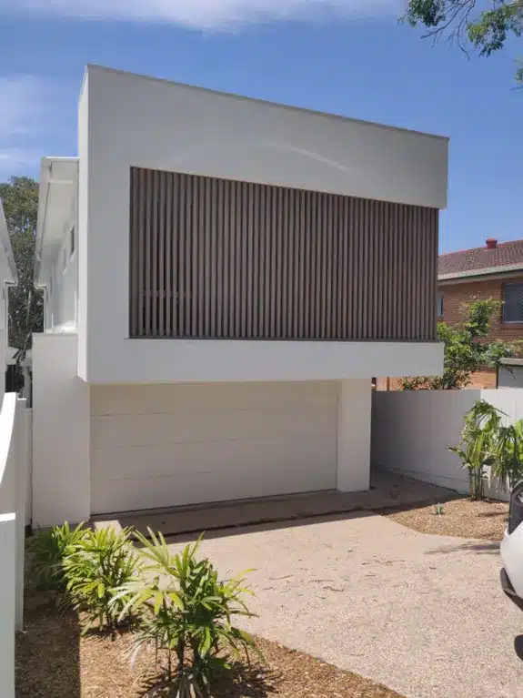 Property Developers Brisbane buyers agent A new build home with a modern wooden and white facade in Brisbane
