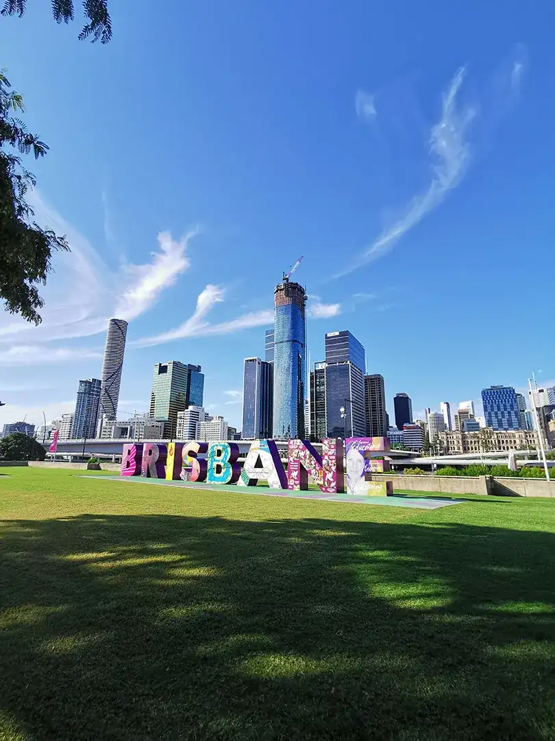 Property Auction Brisbane Brisbane sign with city in the background and Auction bidding service in Brisbane