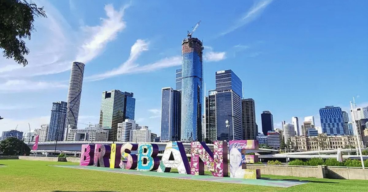 Young couple standing proudly in front of their first home in Brisbane, holding keys with smiles.